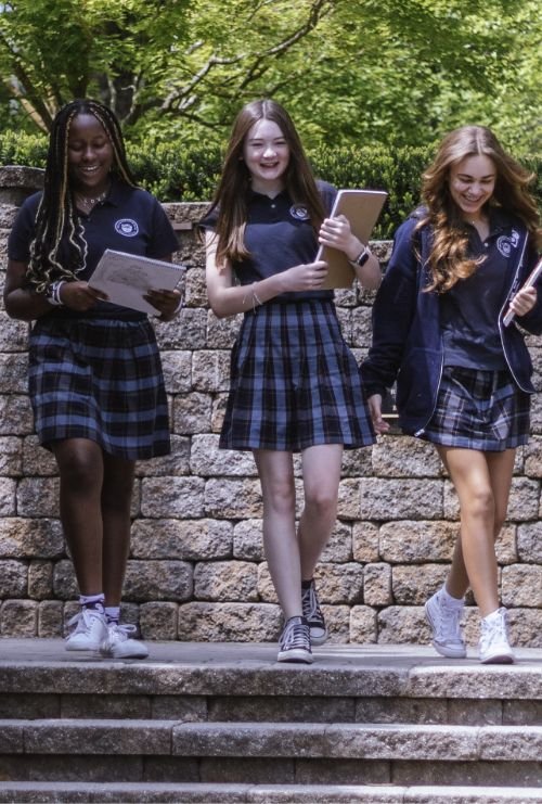 three students walking outside