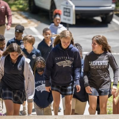 middle school students on stairs entering school building